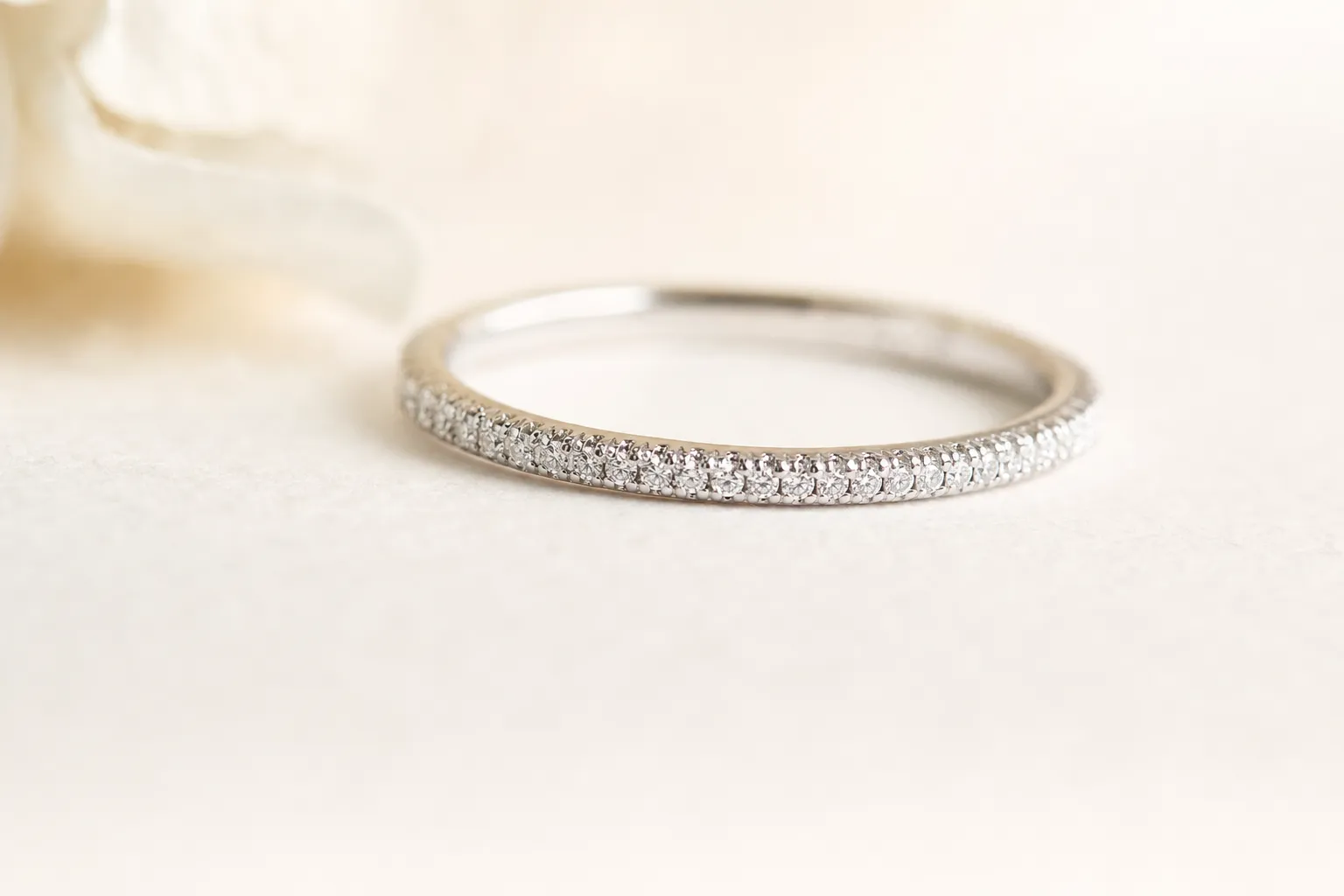 Extreme close-up of a micro-pavé band with dozens of tiny diamonds and barely visible metal